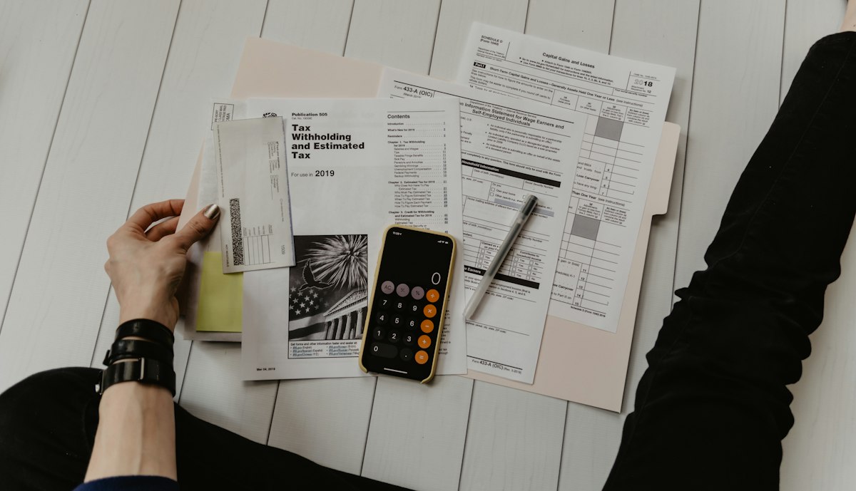 Calculator and documents on a desk used for household cash-flow review